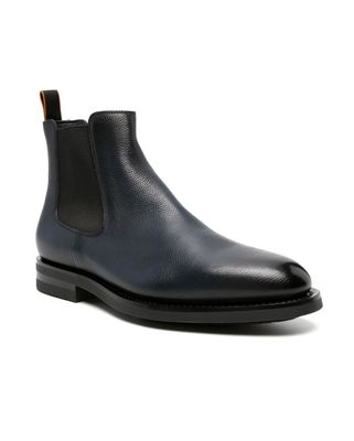 a black leather boot with a rubber sole