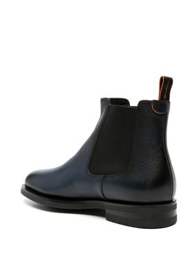 a pair of black chelsea boots on a white background