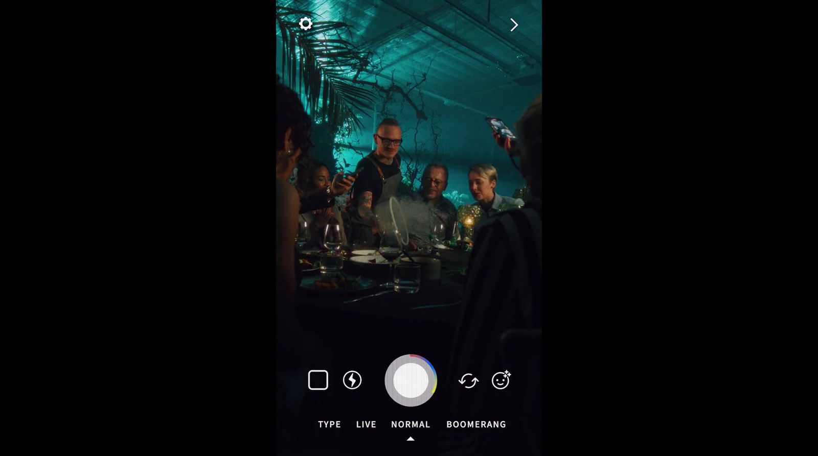 a group of people sitting around a table in a room