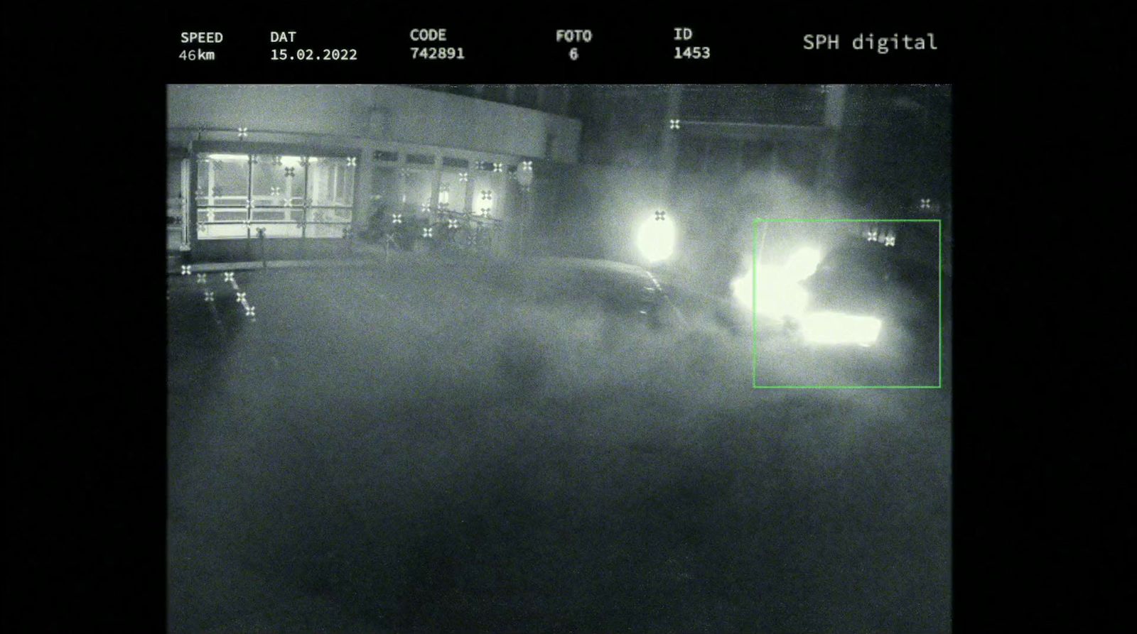 a black and white photo of a car driving down a street