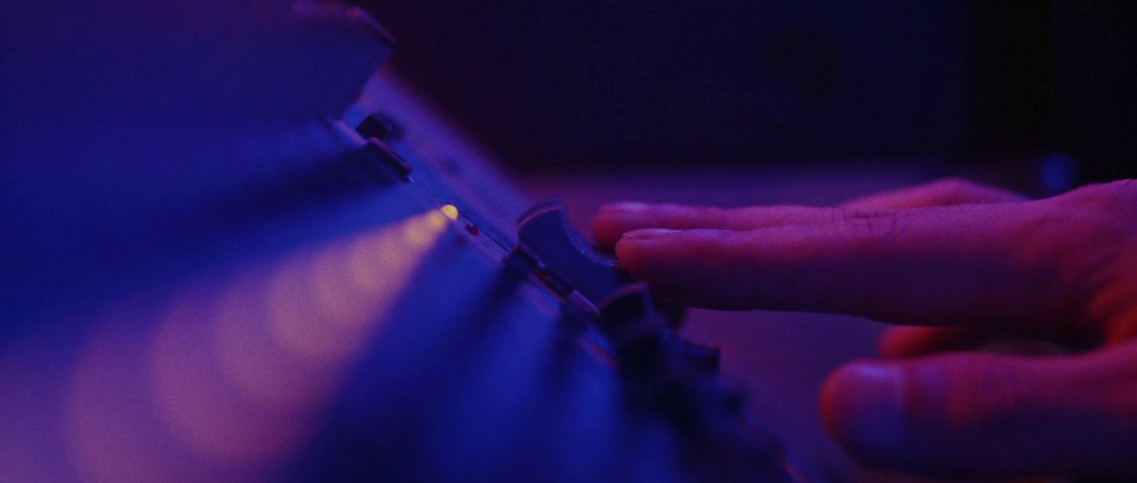 a person is typing on a keyboard in a dark room