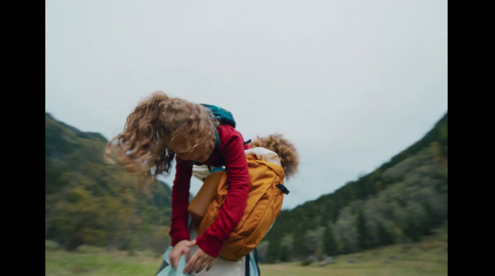 a woman carrying a child on her back