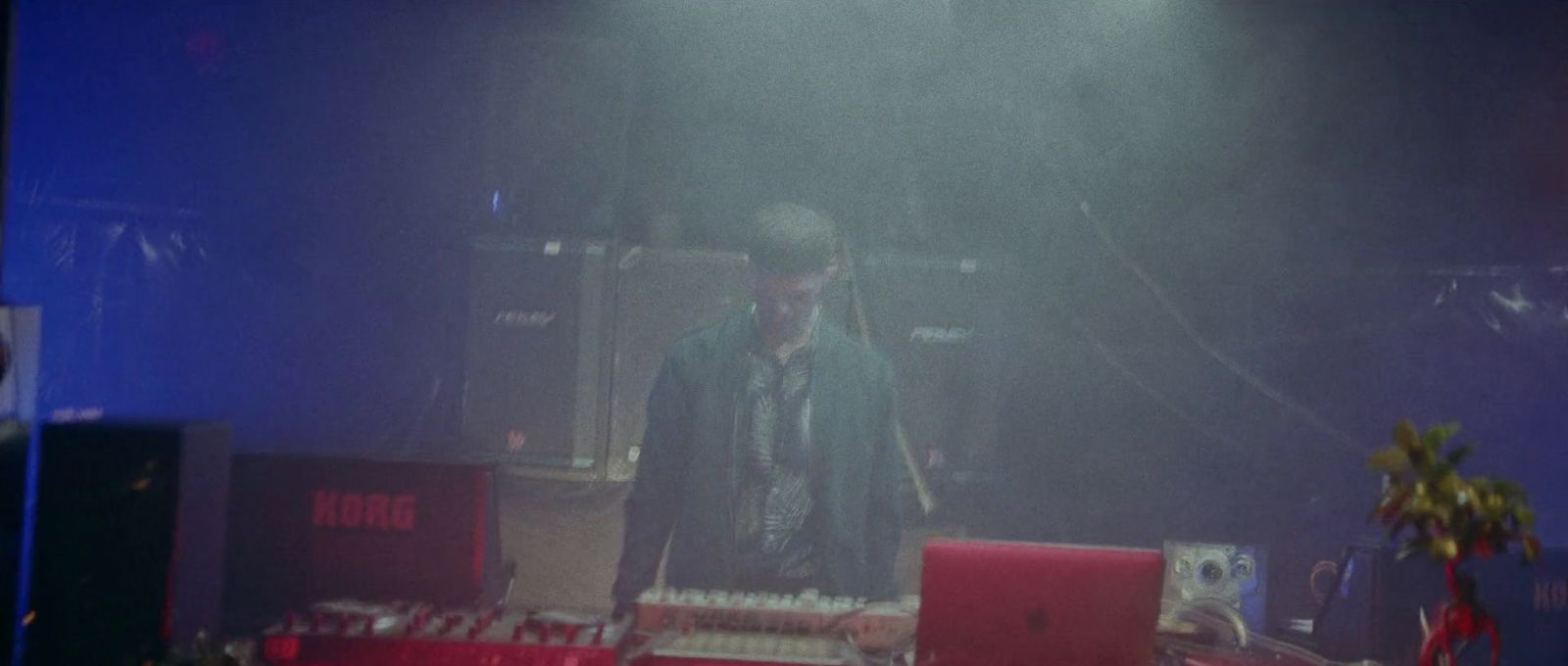 a man standing in front of a laptop computer on a stage