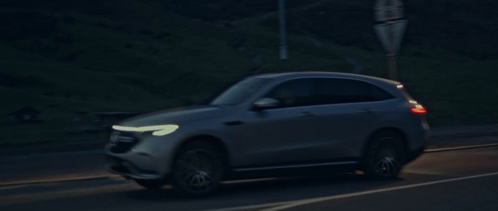 a car driving down a street at night