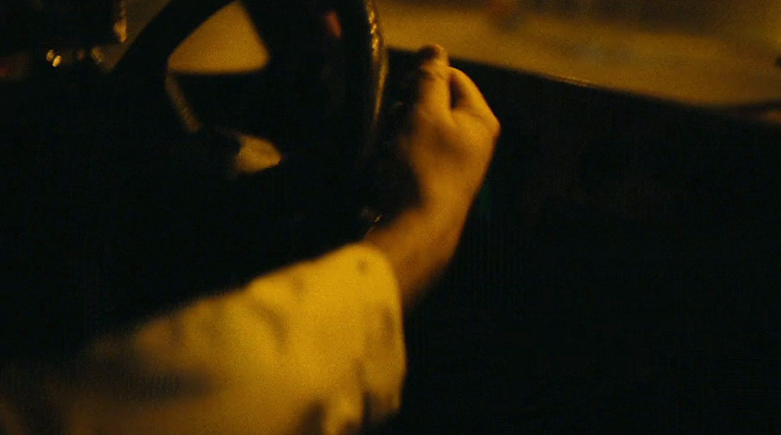 a person driving a car in the dark