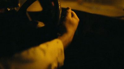 a person driving a car in the dark