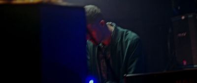 a man standing in front of a keyboard on a stage