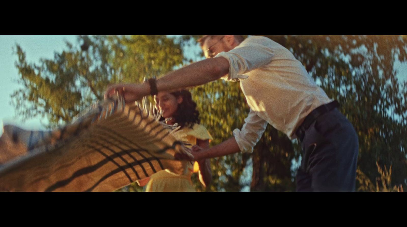 a man holding a tennis racquet on top of a tennis court