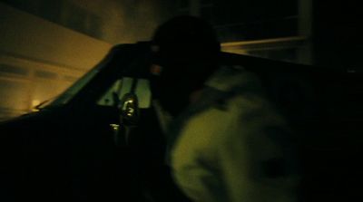 a person sitting in the back of a car at night