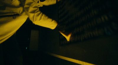 a person standing next to a wall in a dark room