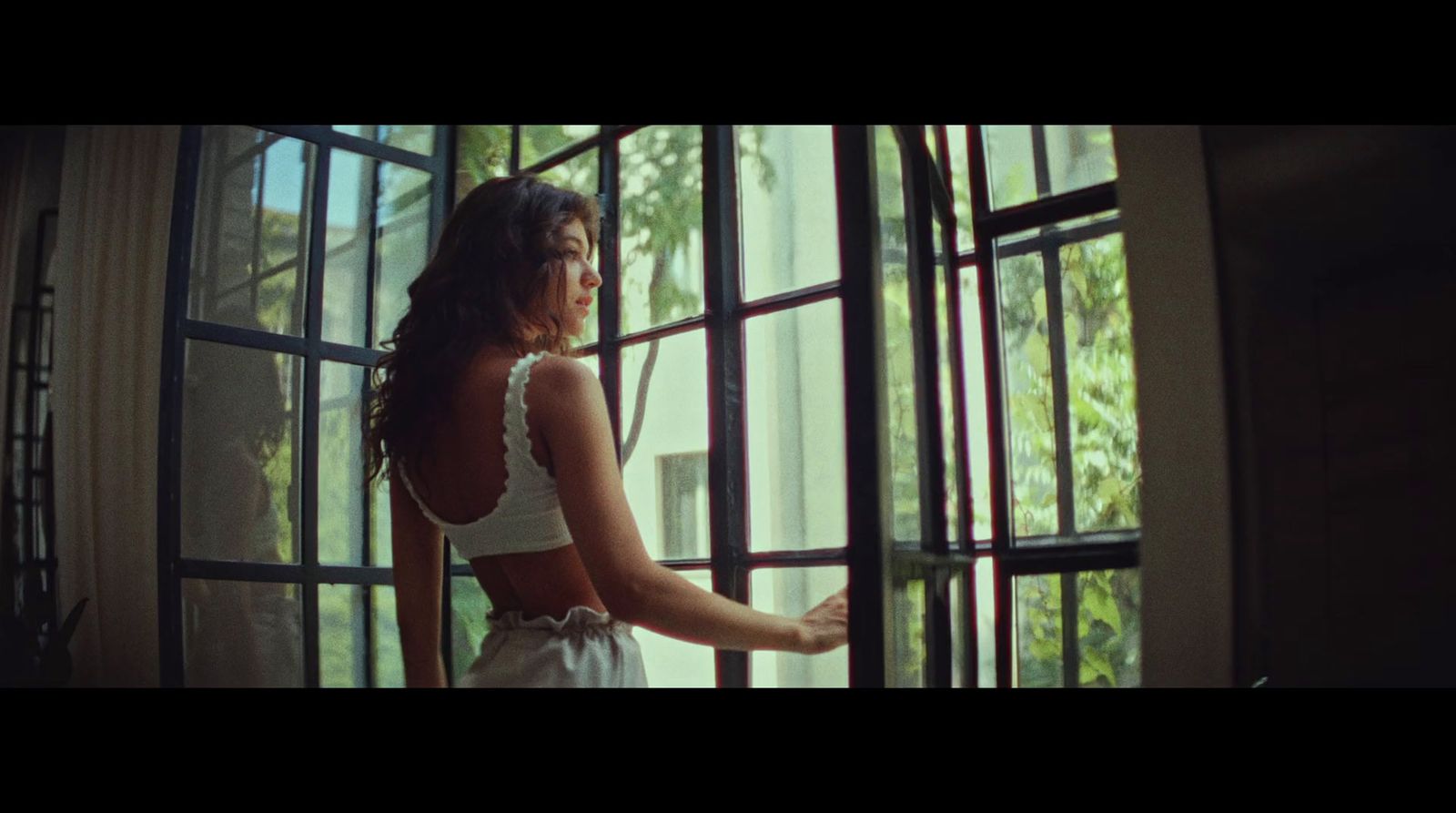 a woman standing in front of a window