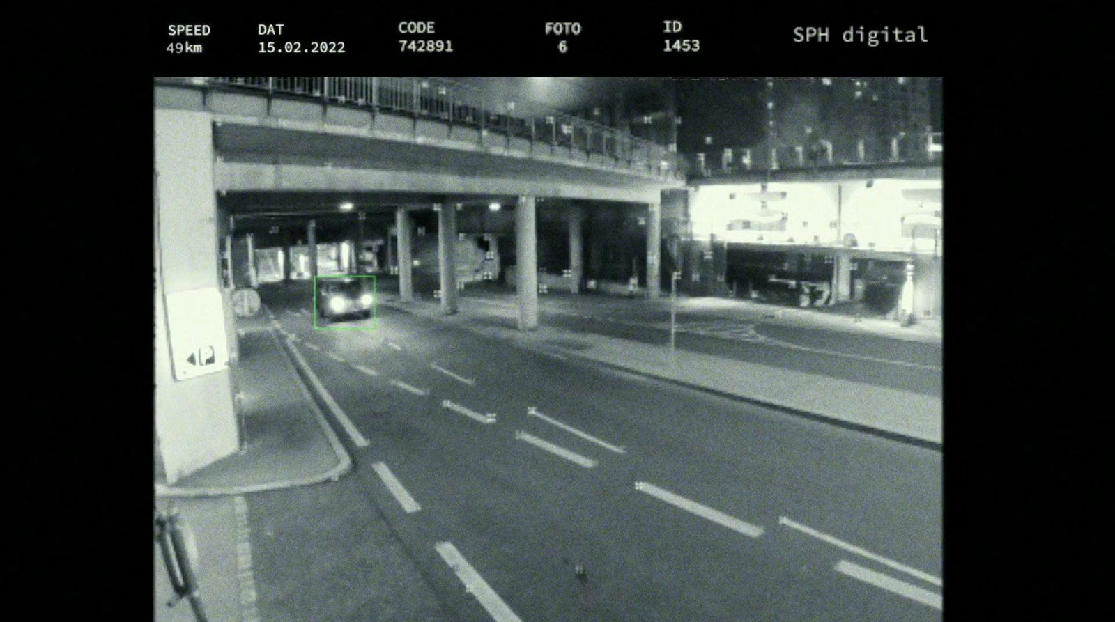 a black and white photo of a street at night