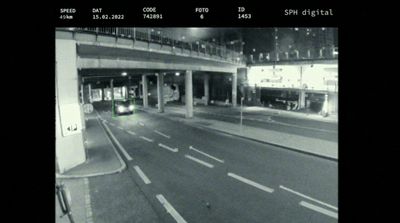 a black and white photo of a street at night