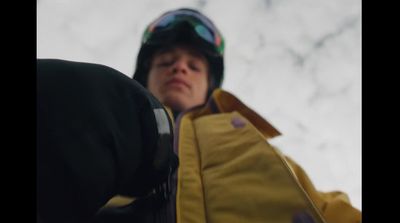 a person in a yellow jacket and goggles