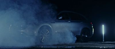 a car with smoke coming out of it at night