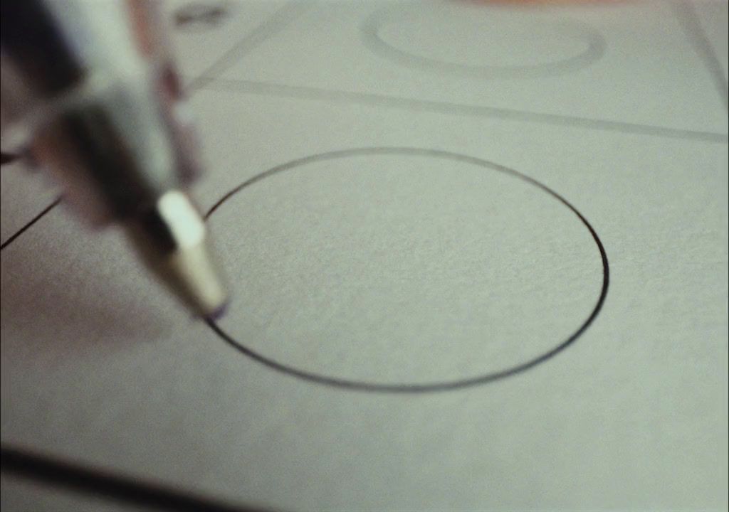 a close up of a pen writing on a piece of paper