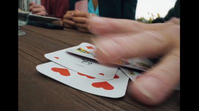 a group of people playing cards on a table