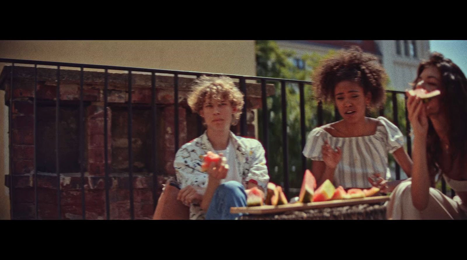 a group of women sitting on a bench next to each other