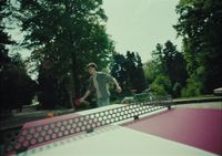 a man riding a skateboard on top of a pink ramp