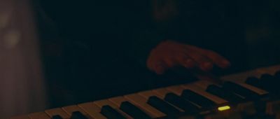 a person playing a keyboard in a dark room