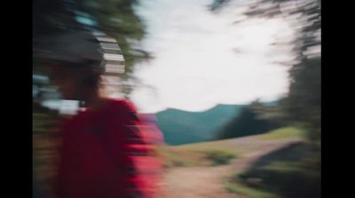 a blurry photo of a person in a red shirt