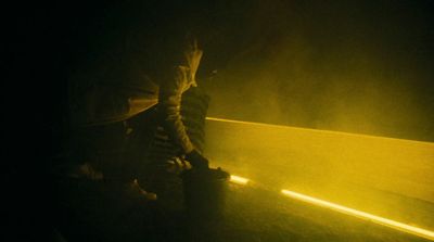 a person sitting on a bench in the dark