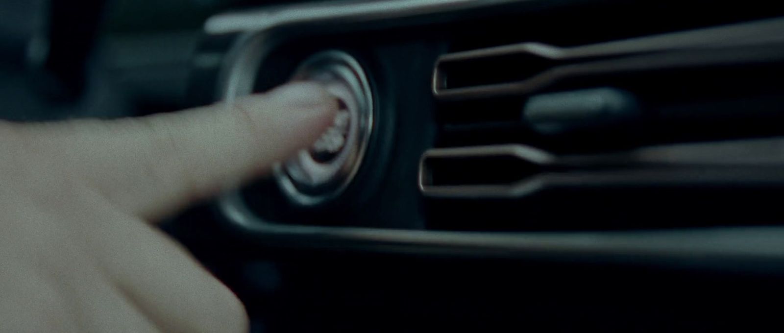 a close up of a person pressing buttons on a car radio