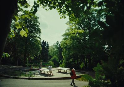 a group of people walking around a park