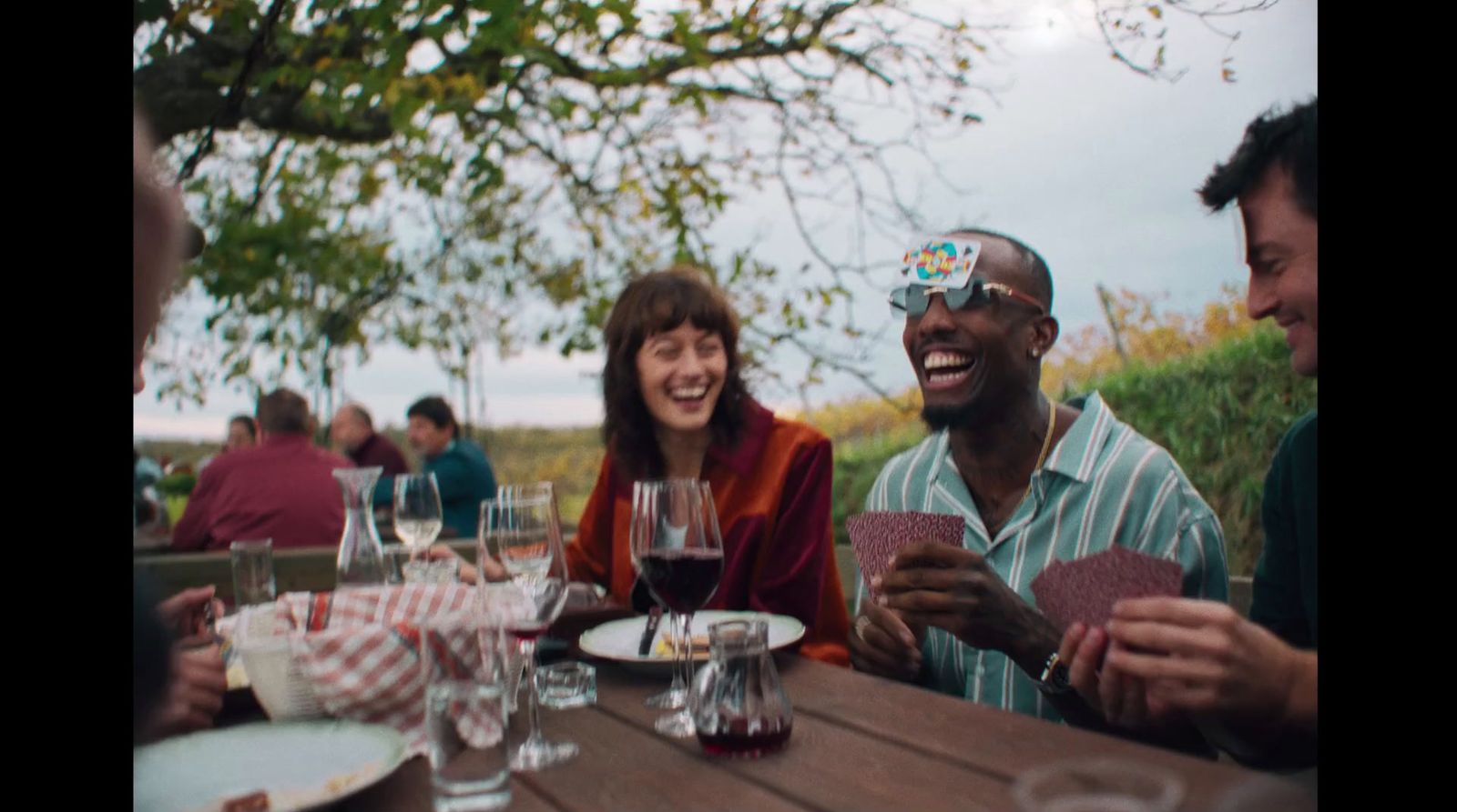 a group of people sitting around a wooden table