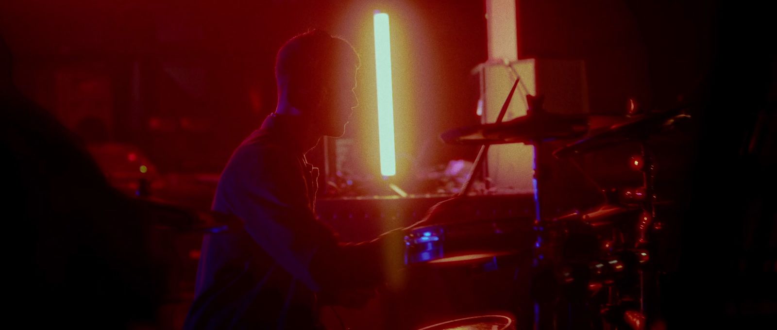 a person playing drums in a dark room