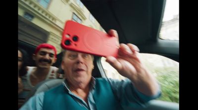 a man holding a red object up to his face