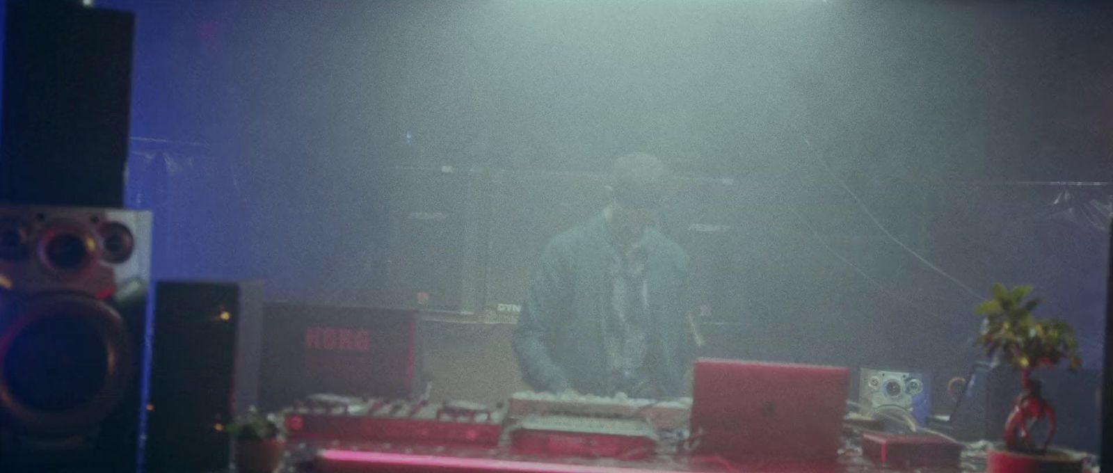 a man standing on top of a stage next to speakers