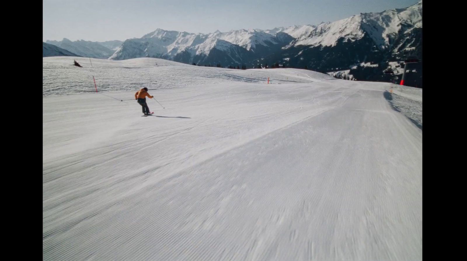 a person riding skis down a snow covered slope