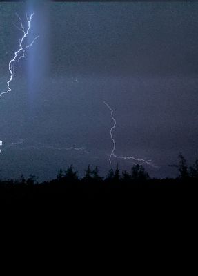 a couple of lightning strikes in the night sky