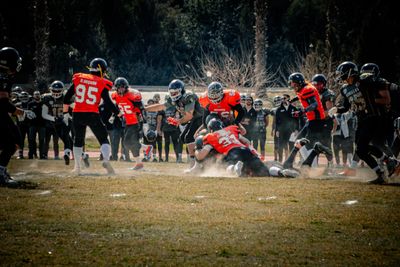 a group of football players playing a game of football