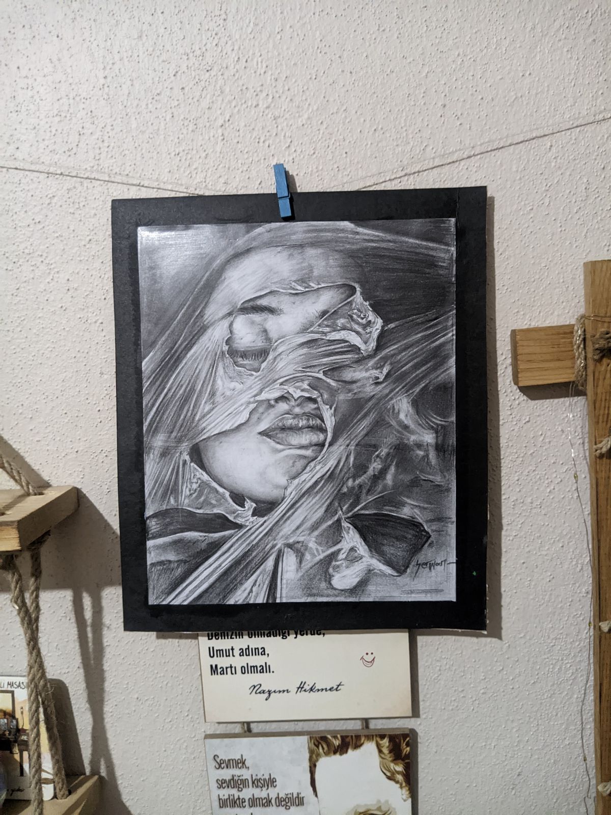 a black and white drawing hanging on a wall