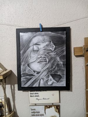 a black and white drawing hanging on a wall