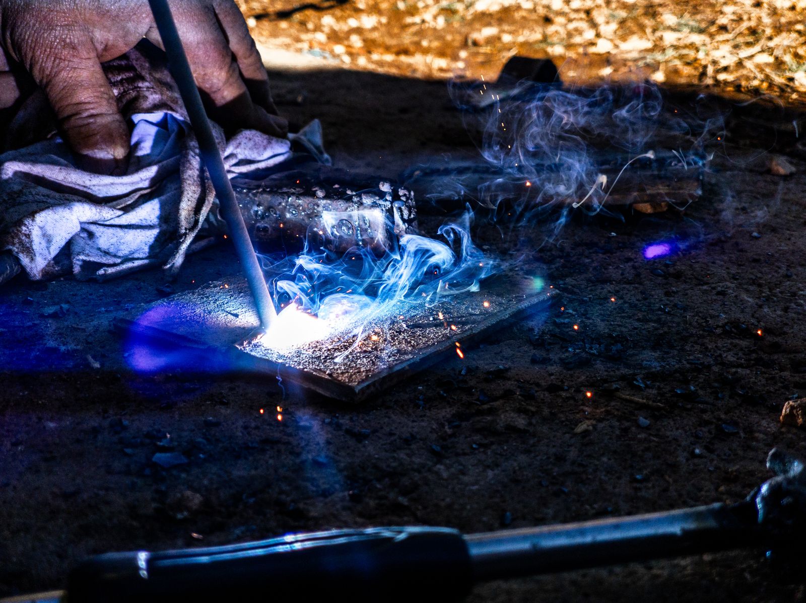 a person lighting a piece of glass on a table