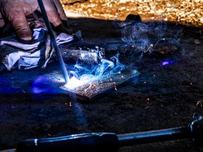 a person lighting a piece of glass on a table