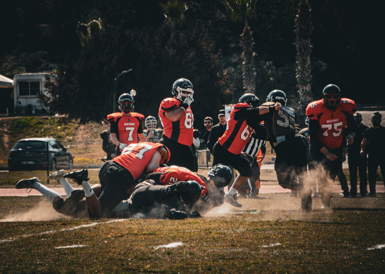 a group of people on a field playing football