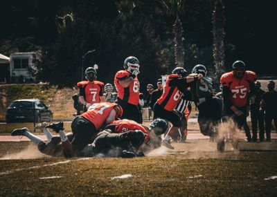 a group of people on a field playing football
