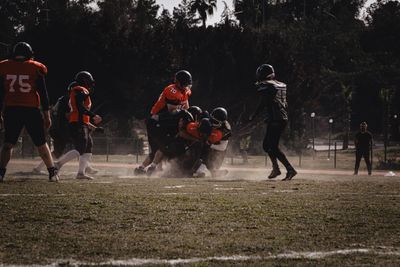 a group of people playing a game of football