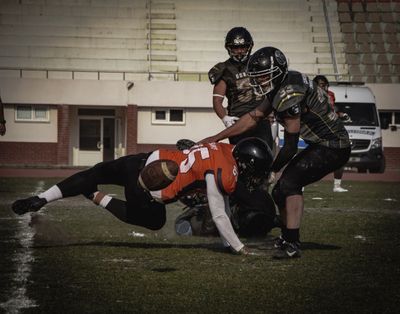 a group of football players playing a game of football
