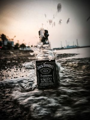 a bottle of jack daniels rum in the water