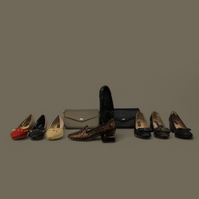 a row of shoes and a purse sitting on top of each other