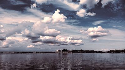 a large body of water under a cloudy sky