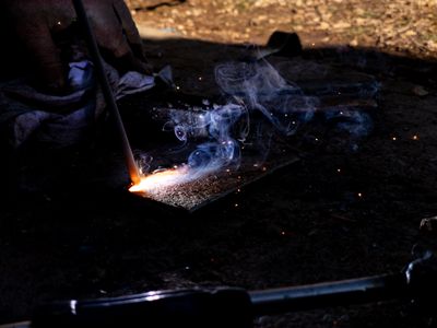a person lighting a cigarette in the dark