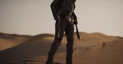 a man standing in the middle of a desert