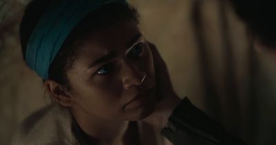 a woman with a blue headband looking at another woman