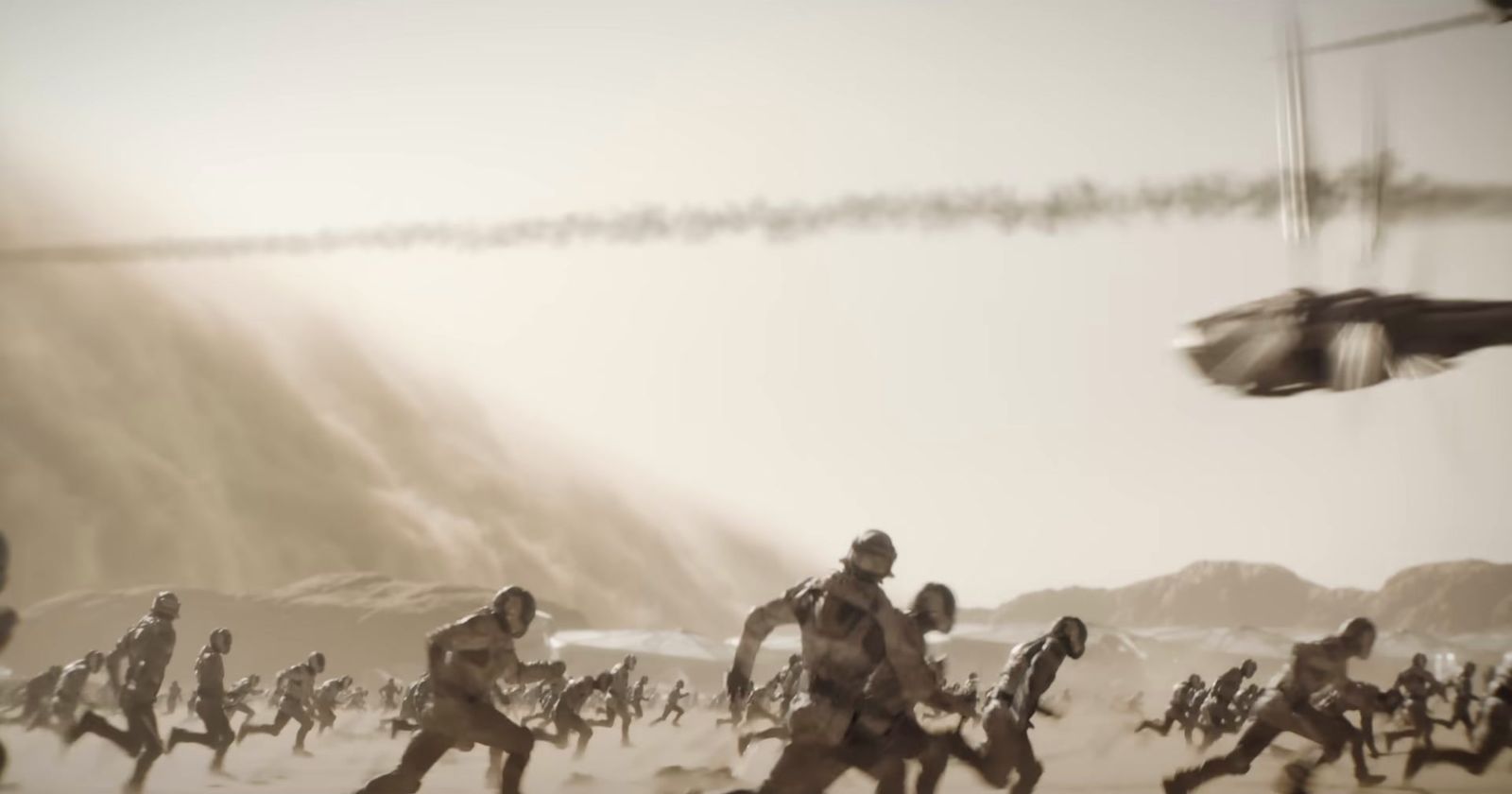 a group of people running across a sandy beach